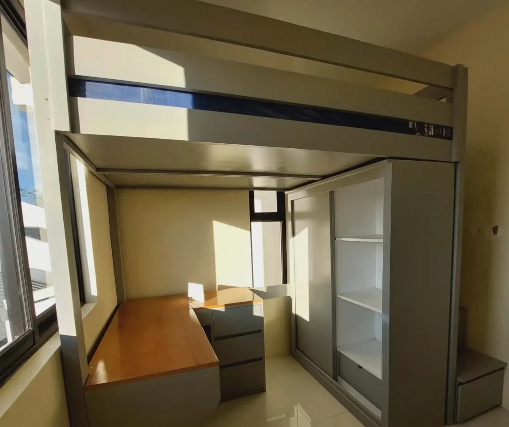 Loft bed with desk and wardrobe in a sunlit room