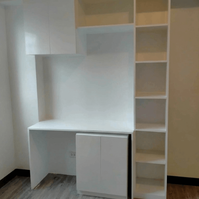 Custom study desk with built-in shelving, overhead cabinets, and modern space-saving storage design.