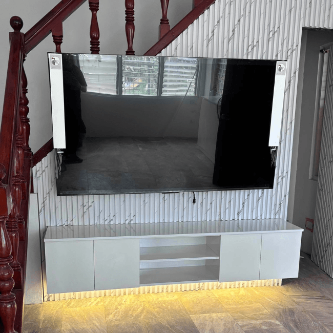 Modern custom TV console with LED backlit wood slat wall, floating cabinet, and built-in shelving.